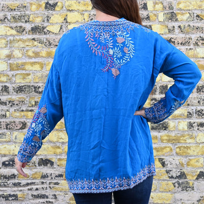 View of Johnny Was Sundae Tunic in Mediterranean Blue with floral embroidery and henley neckline