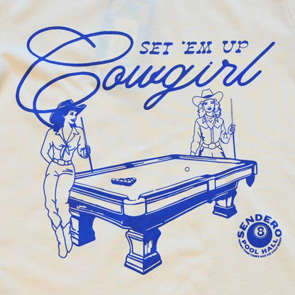Unisex cream tee by Sendero with graphic of two cowgirls playing pool and “Set ’Em Up Cowgirl” text