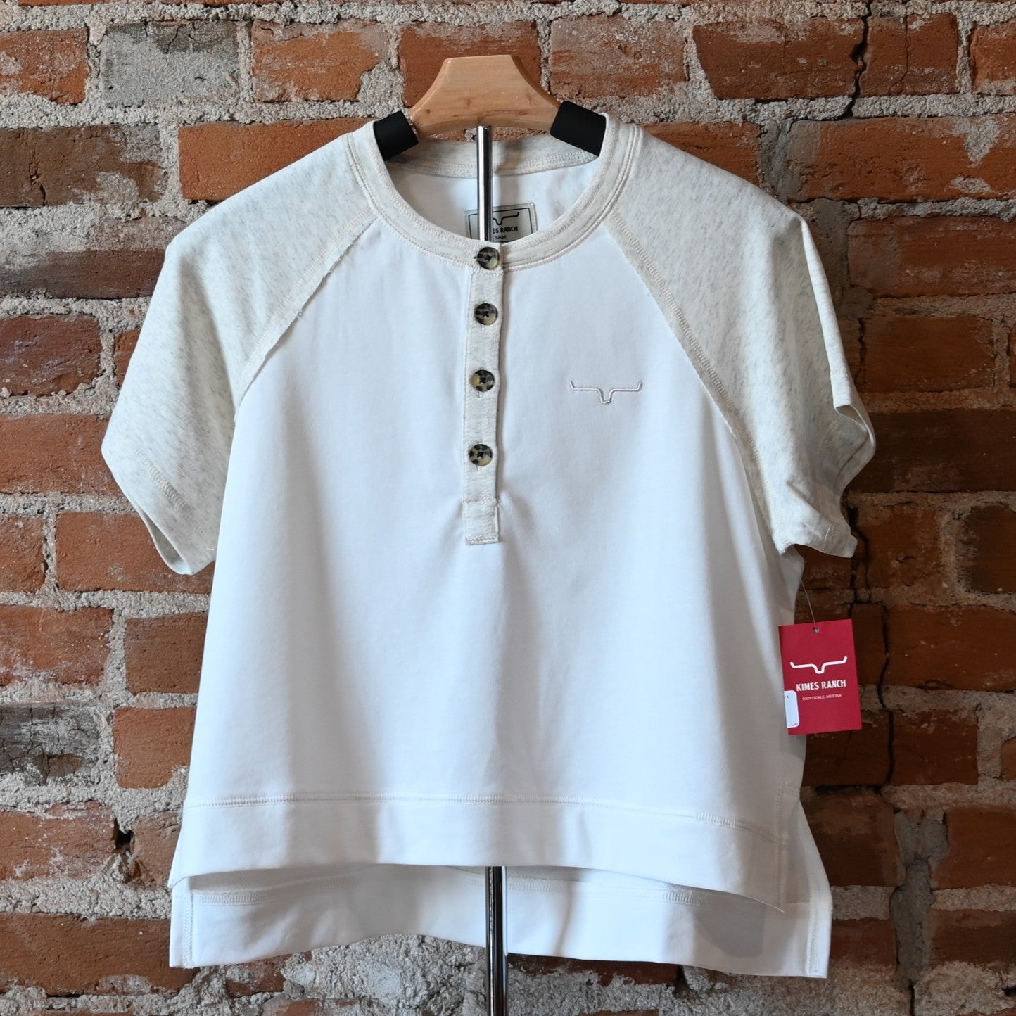 View of Kimes Ranch Hellena Cropped Henley Shirt in Pristine, featuring a cropped fit and button-front placket