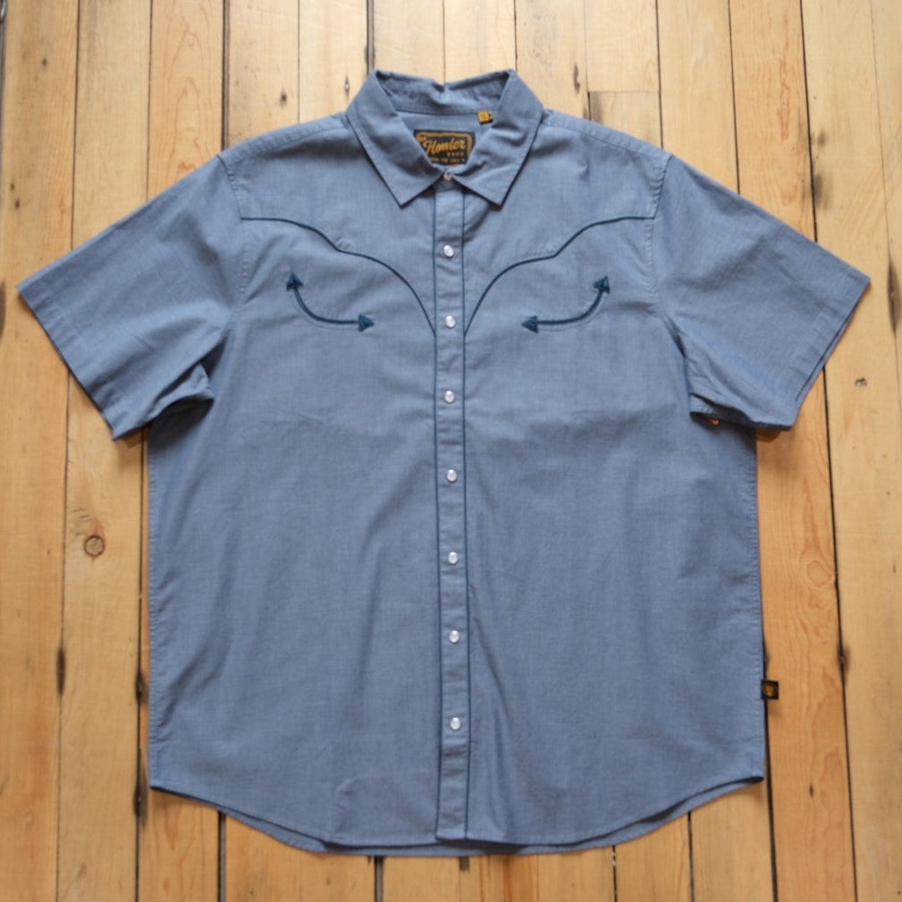 Howler Brothers Broncbuster snapshirt in Indigo featuring contrast piping and pearl snaps.