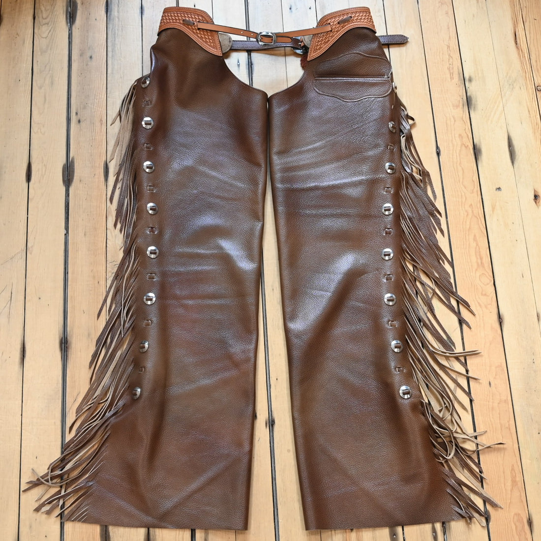 View of K Bar J Puncher Versatility Chap in Size Large with basket weave tooling and slotted conchos