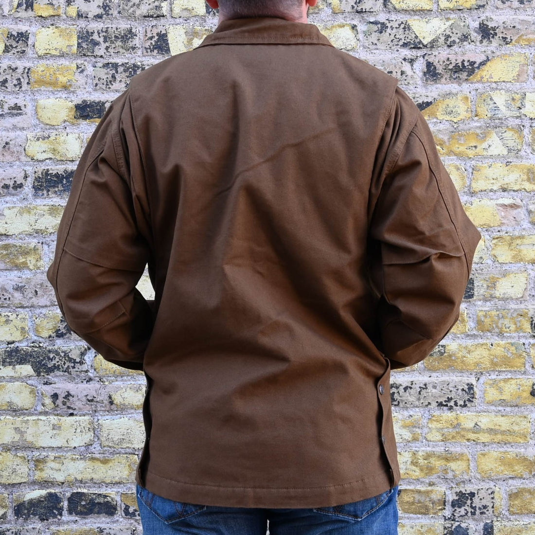View of Schaefer tobacco-colored canvas ranch jacket with quilted liner, snap-out ride vents, and multiple utility pockets