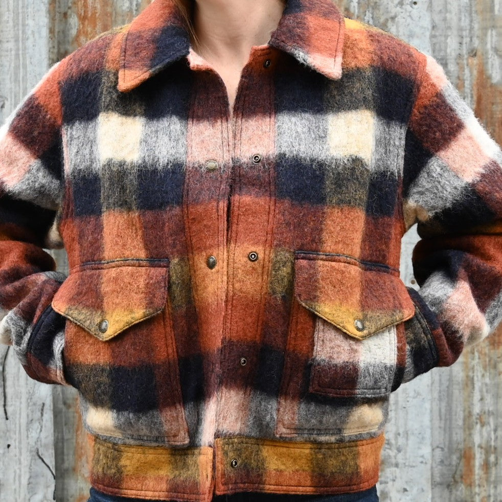 Filson Ladies Blanket Wool Heritage Jacket in red, orange, and black plaid with snap-front design