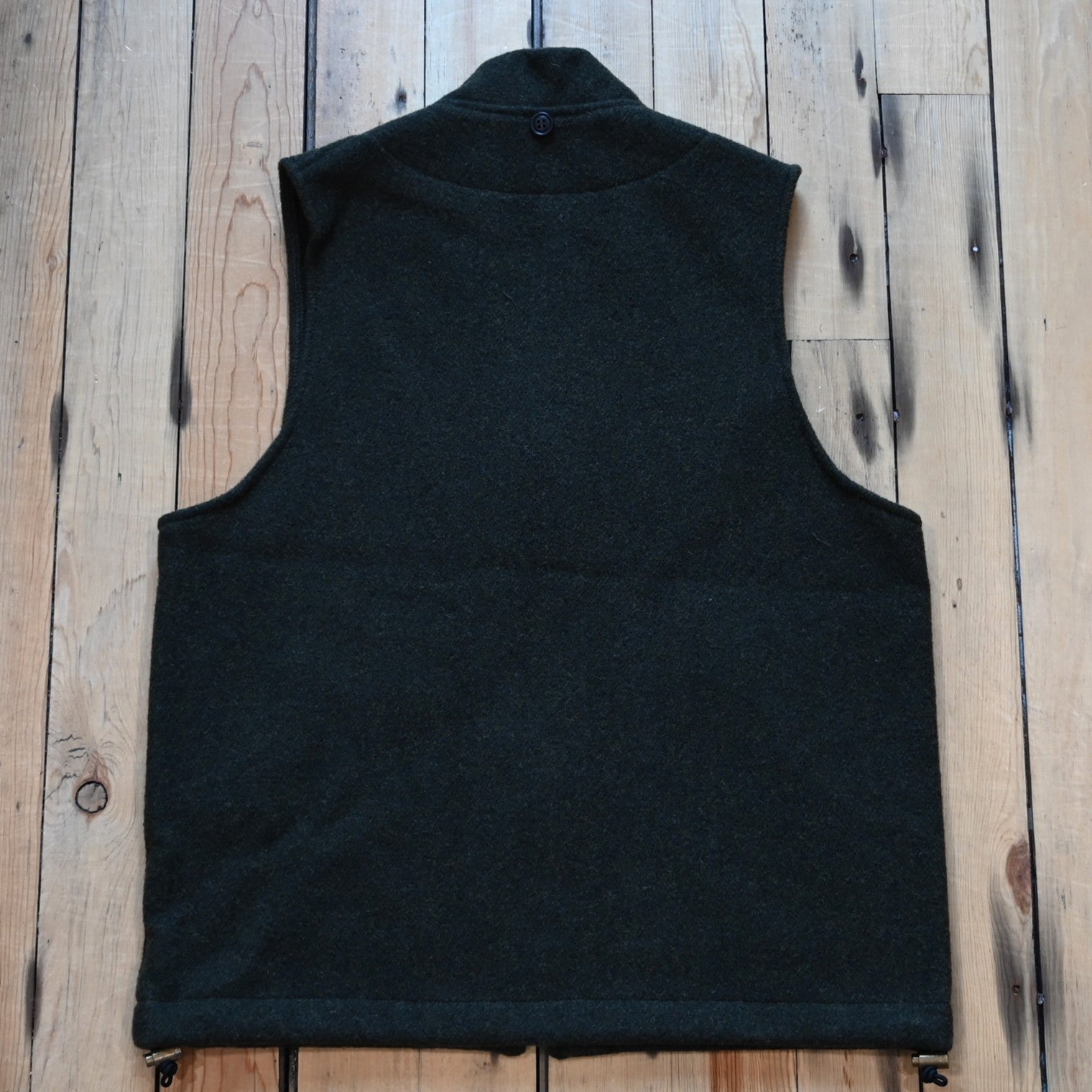 Forest green Filson Mackinaw Wool Vest Liner with zip-front, hand-warmer pockets, standing collar, and drawcord waist