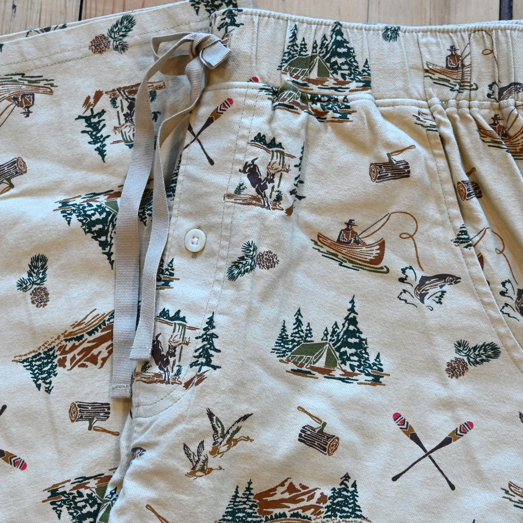 View of Pendleton men’s forest scene flannel pajama pants with tents, deer, and fishing print
