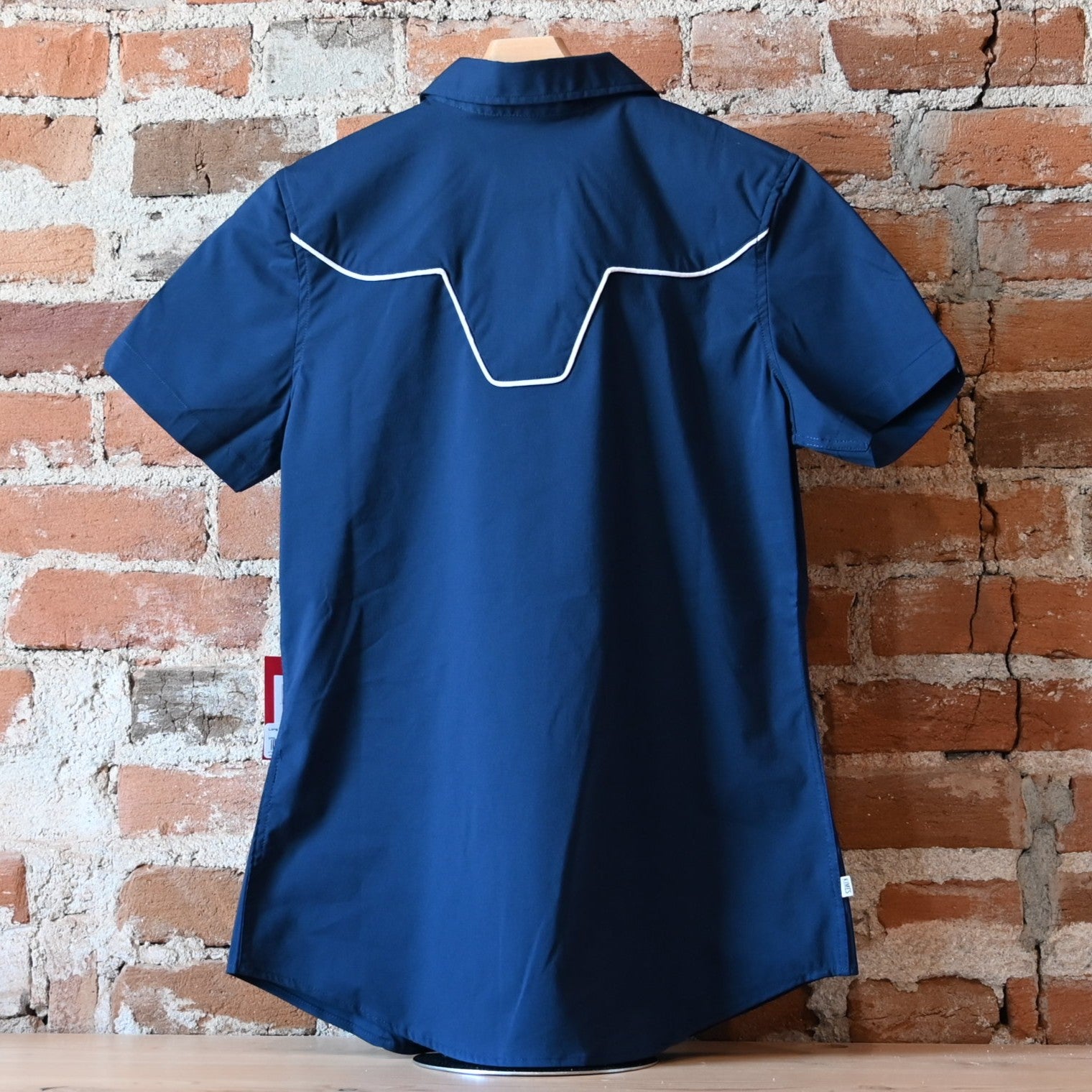 View of Kimes Ranch Long Horn Top in Navy, featuring a short-sleeve design, vintage arrow accents, and a subtle longhorn logo