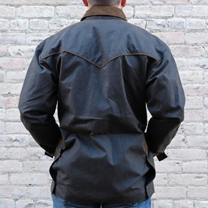 View of Oak waxed canvas RangeWax Drifter coat with leather collar, corduroy trim, pockets, and storm flap