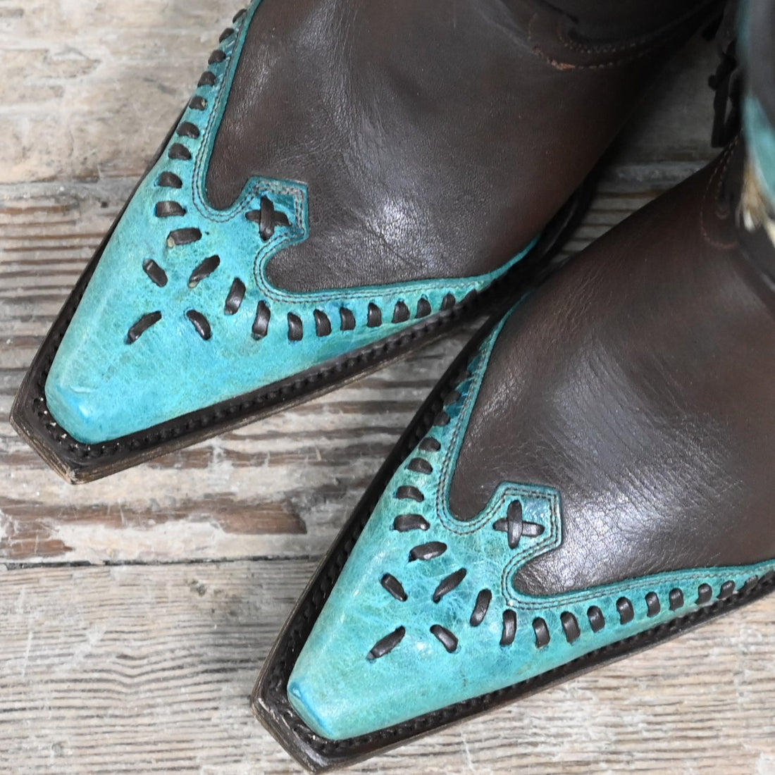 View of Lucchese ladies 11″ boot in chocolate leather with powder blue toe and collar, buckstitch trim, and tassel