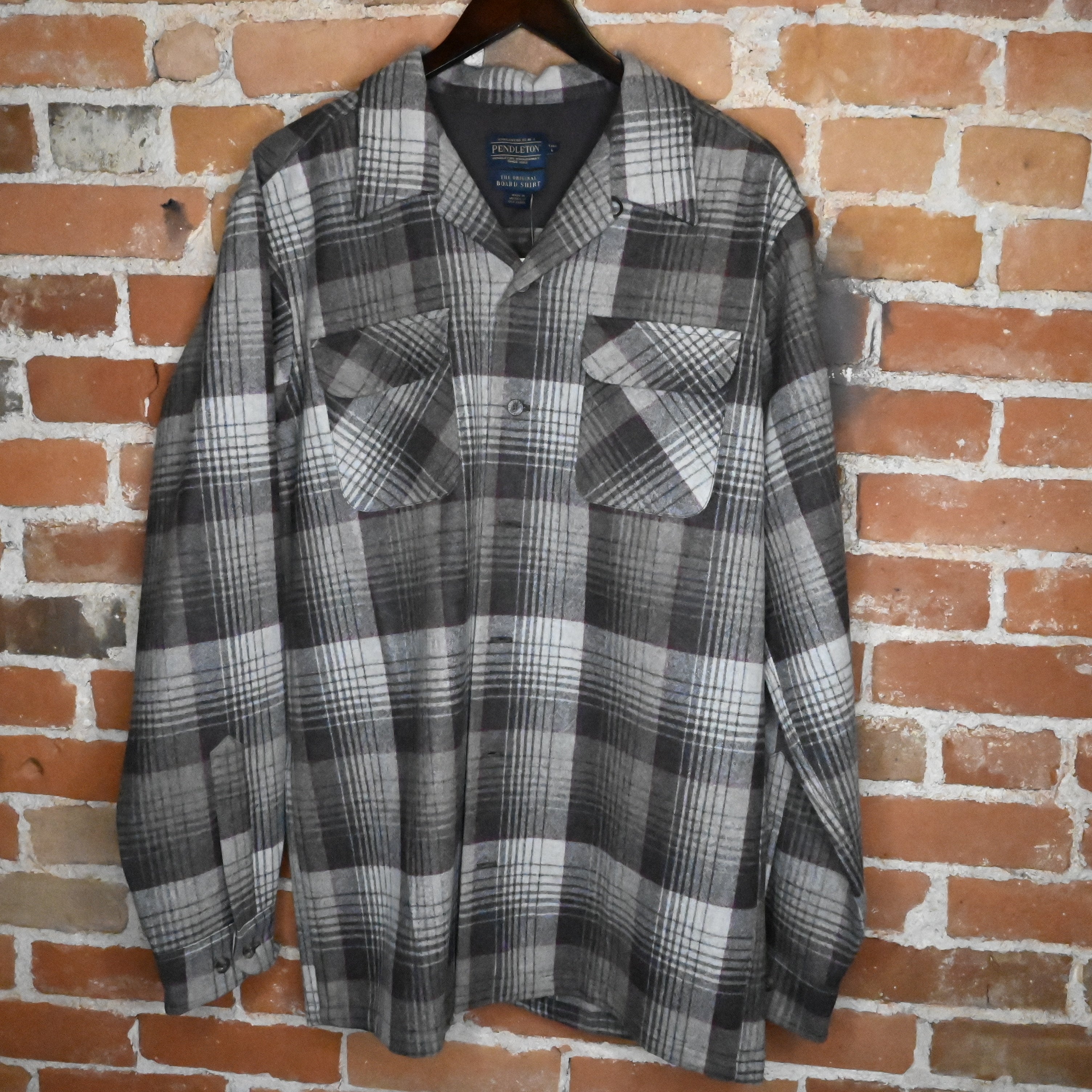 View of Pendleton men’s tall black and grey plaid wool board shirt with square hem