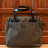 Filson rugged twill zip-top tote bag in otter green with leather handles and multiple exterior pockets