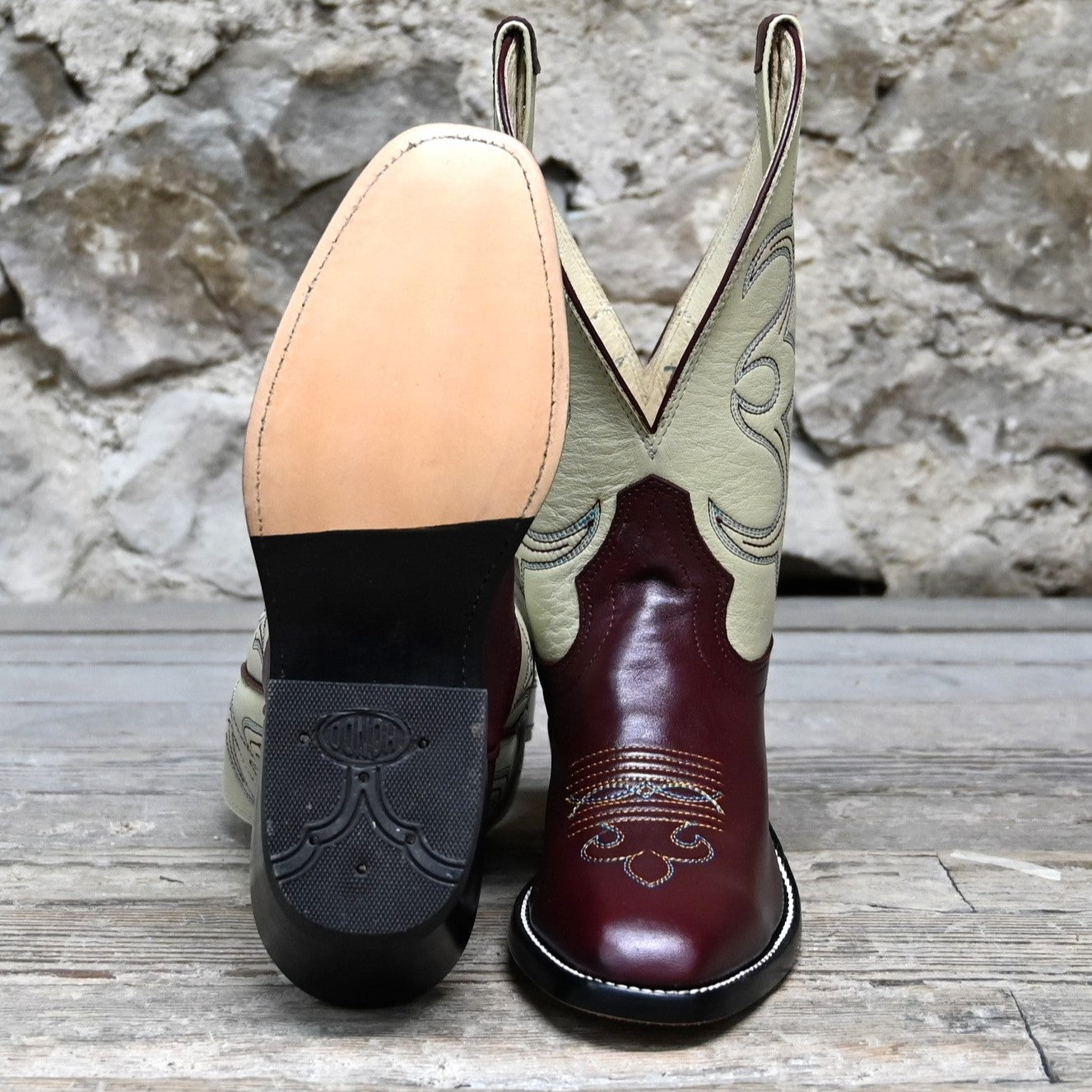 View of Atomic 79 exclusive Hondo Bronc Boot with bone top, burgundy vamp, French square toe, and spur lip