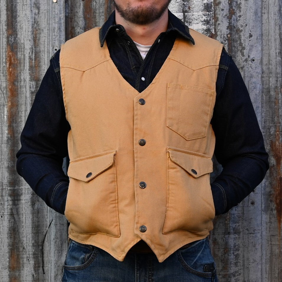 View of Schaefer sherpa-lined canvas vest in suntan with drop-tail hem and five-pocket front