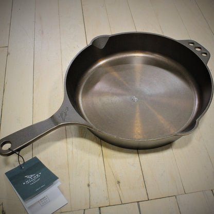 View of Smithey Ironware No. 10 Cast Iron Skillet with polished interior and ergonomic handle