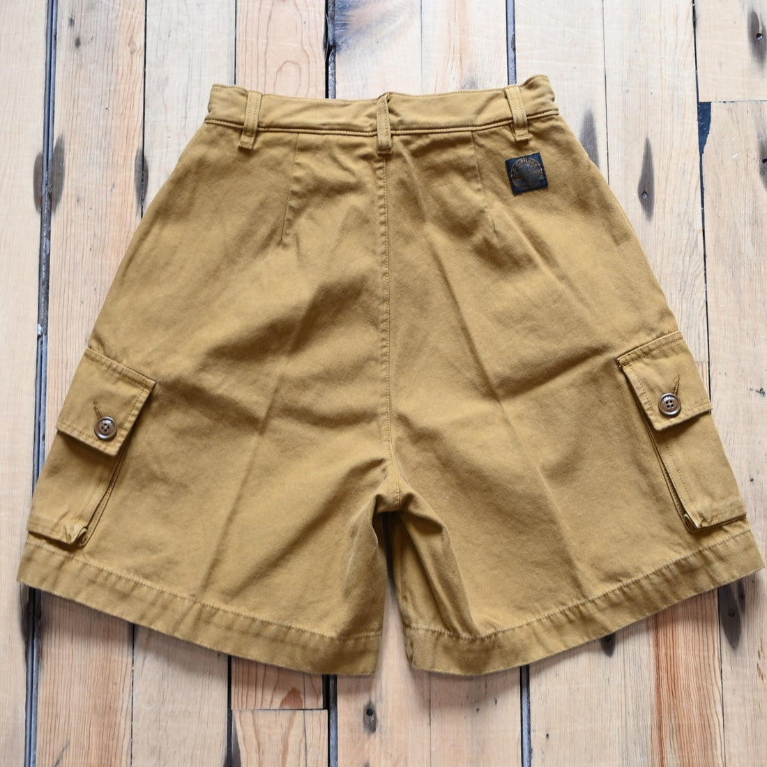 View of Filson Ladies Field Camp Shorts in Dark Ochre featuring button-flap cargo pockets and tailored fit