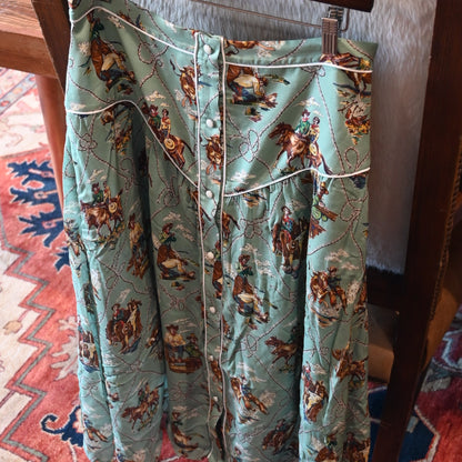 View of Double D Ranch Romance &amp; Rustlers Skirt featuring a custom Western print, contrast piping, and pearl snap placket in a midi A-line silhouette