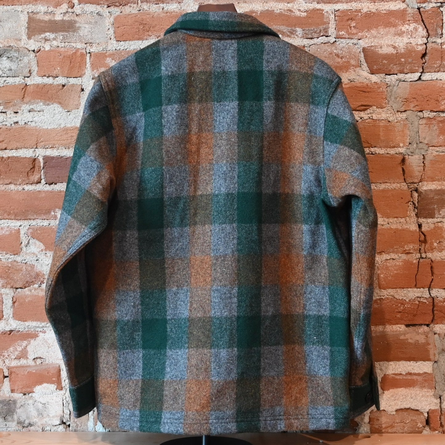 Filson Mackinaw Wool Jac-Shirt in Green, Orange, and Gray Plaid with button-front and chest pockets