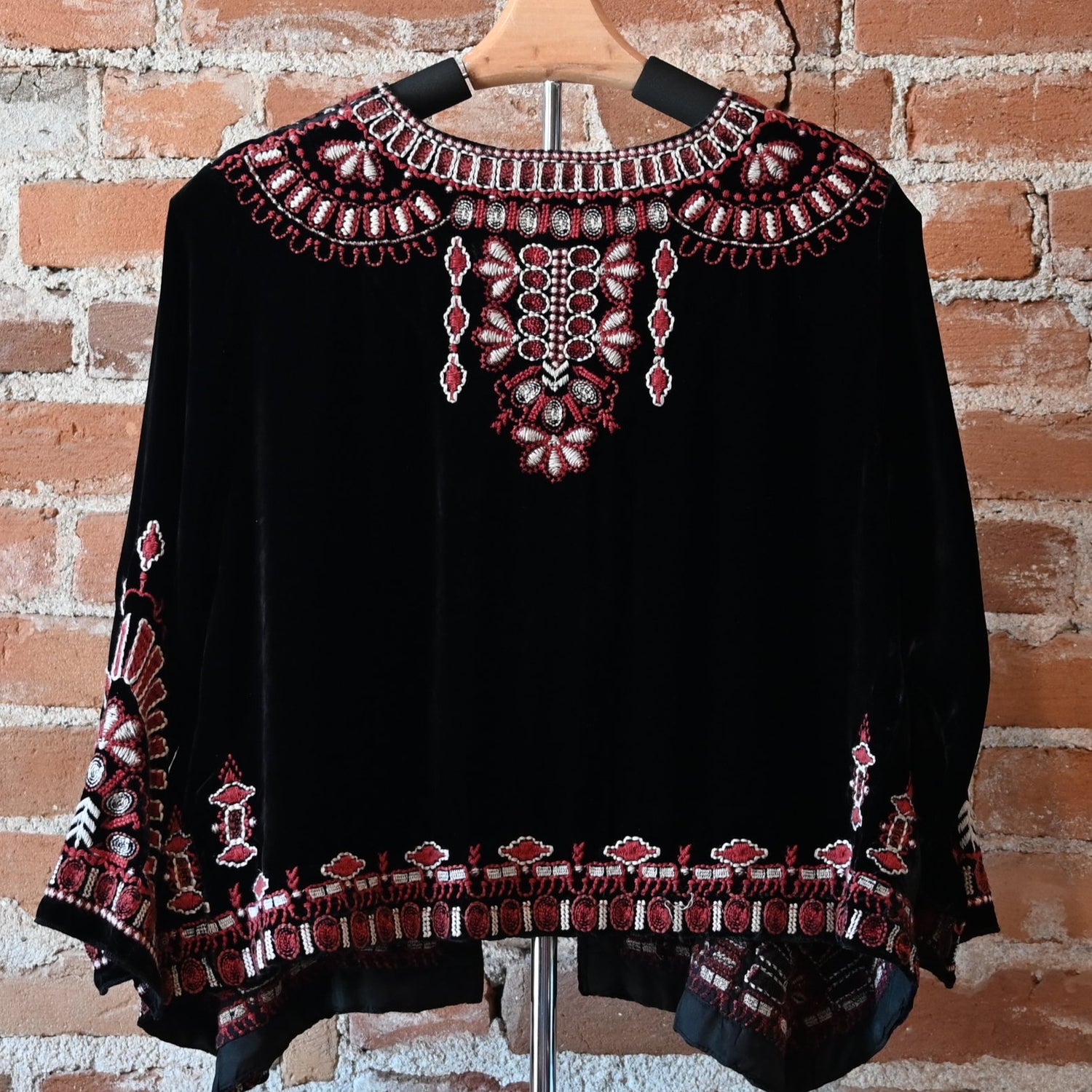 View of Johnny Was black velvet bolero with red and white embroidered floral trim