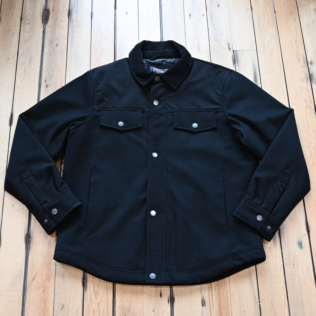 View of Pendleton Men’s Timberline shirt jacket in black wool blend with quilted lining and corduroy shoulder detail