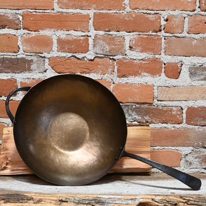 View of Smithey Ironware Carbon Steel Wok with hand-hammered surface and gooseneck handle