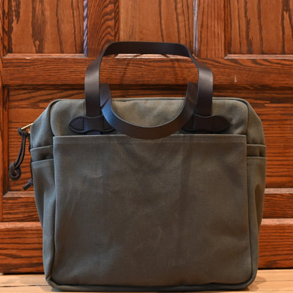 Filson rugged twill zip-top tote bag in otter green with leather handles and multiple exterior pockets