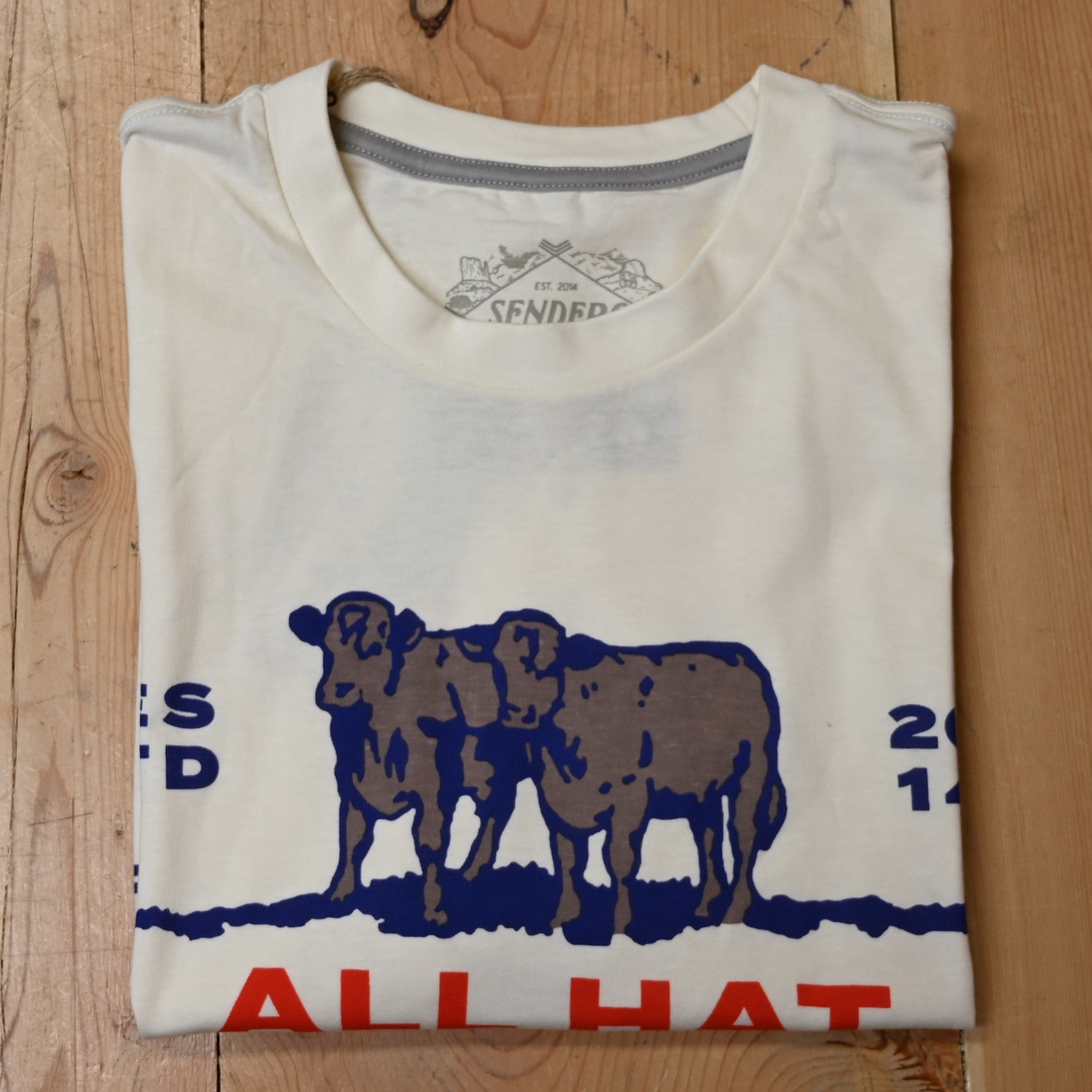 View of Sendero “All Hat No Cattle” T-Shirt in natural with red lettering