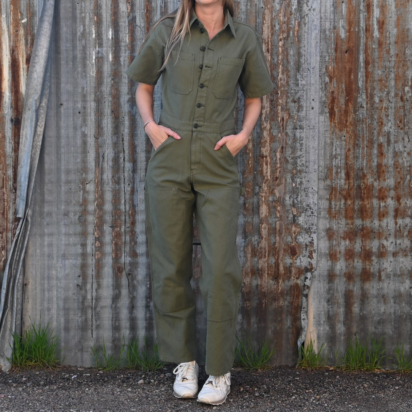 View of Filson Ladies Field Short Sleeve Coverall in Army Green featuring double-layer leg fronts, tool pockets, and hammer loop