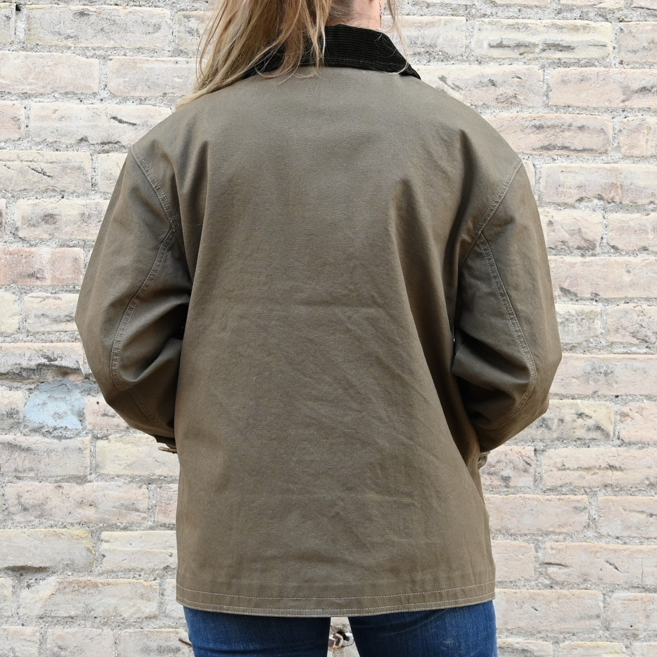 View of Filson Ladies Barn Coat in Marsh Olive featuring button-front closure and corduroy-lined collar