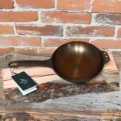 View of Smithey Ironware No. 8 Cast Iron Chef Skillet with polished interior and ergonomic handle