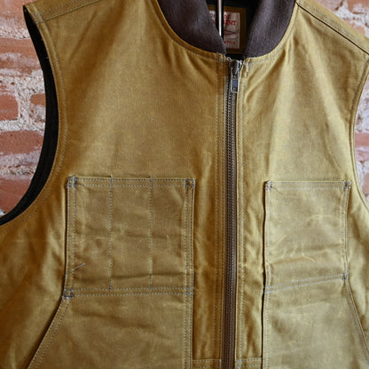 View of Filson Tin Cloth Insulated Work Vest in Dark Tan, showcasing durable Tin Cloth fabric and multiple functional pockets