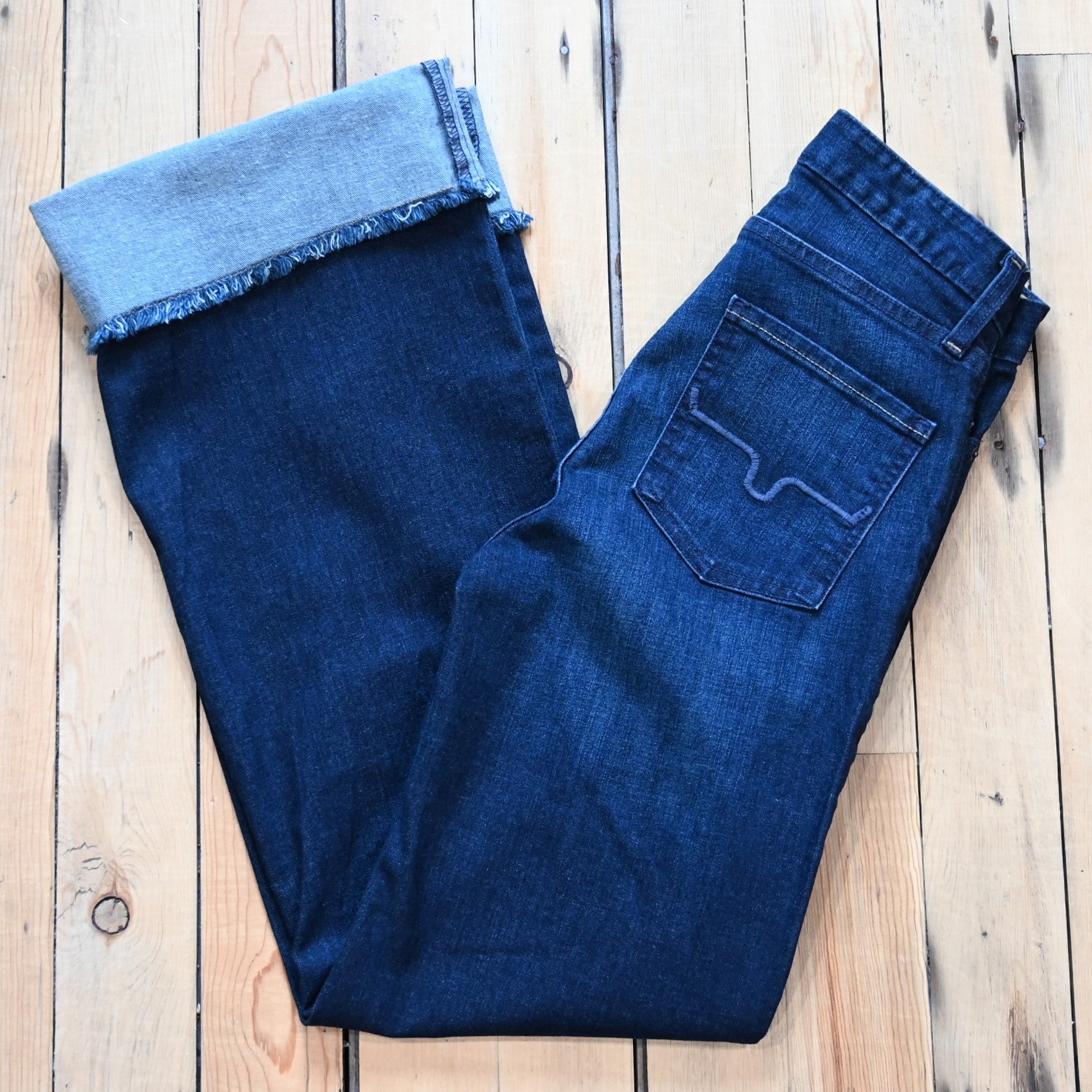 Kimes Ranch Olivia dark wash wide-leg jeans with raw hem and high-rise fit.