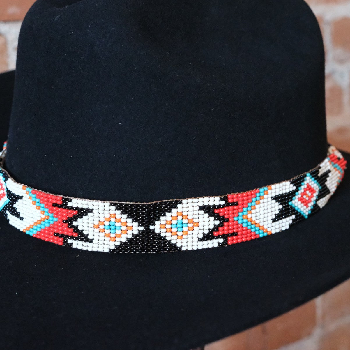 Adjustable Sambboho Phoenix beaded hatband styled on a western felt hat at Atomic 79.