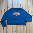 View of Kimes Ranch Ladies Colfax Crew Sweatshirt in Mid Blue, featuring an oversized fit, ribbed hem, and embroidered logo