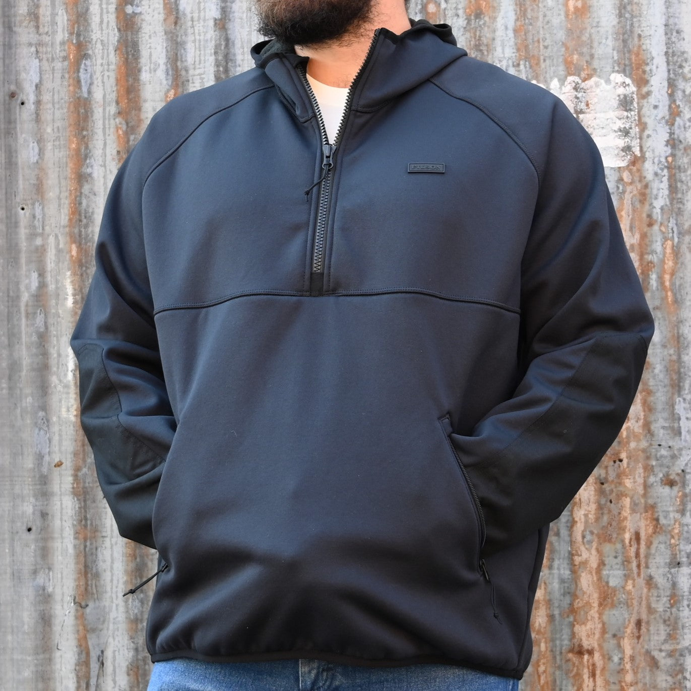 View of Filson Granite Spire Fleece Pullover in Black featuring Cordura® nylon-reinforced forearms and microfleece-lined handwarmer pockets