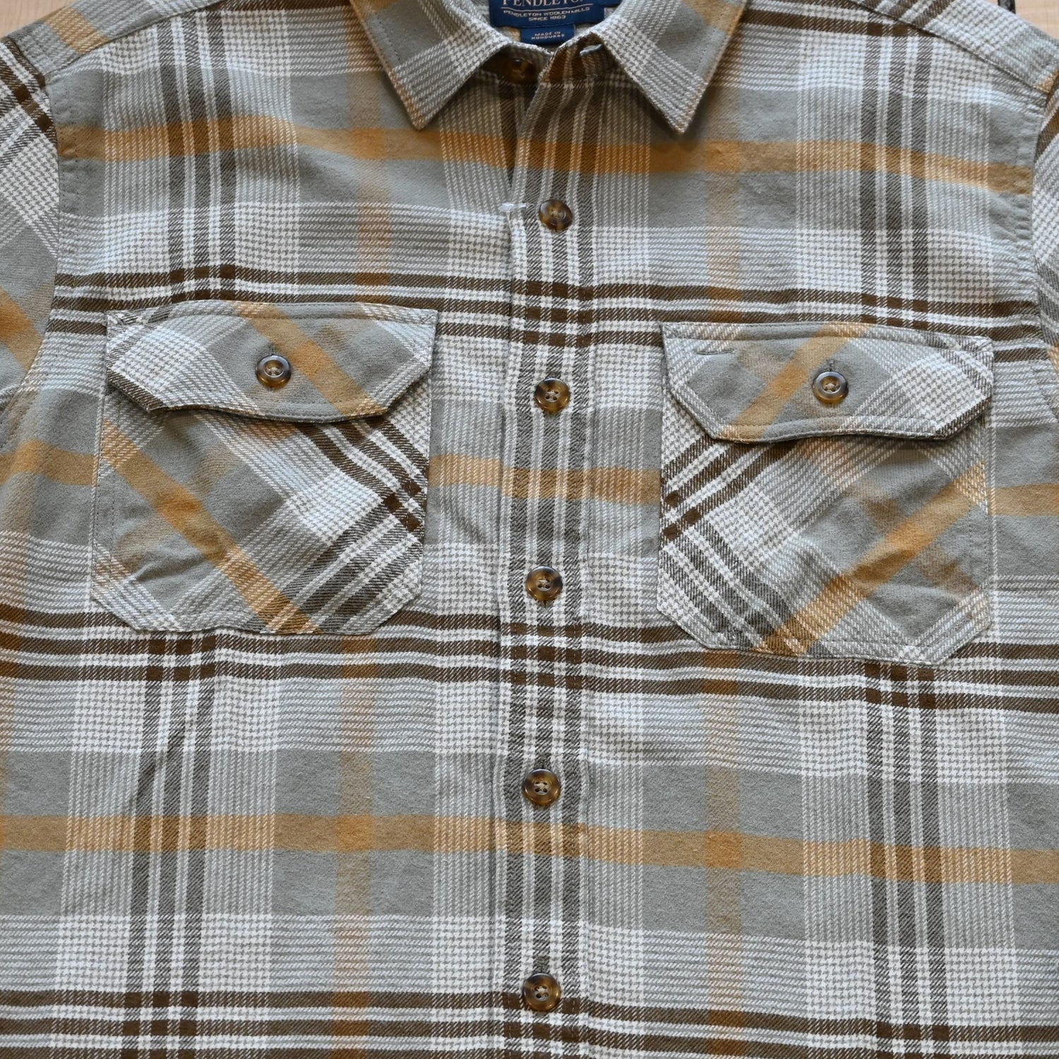 View of Plaid button-up shirt in tan, brown and grey by Pendleton Burnside style