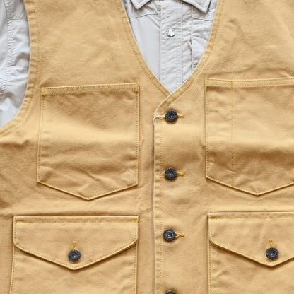 View of Schaefer brushcloth vest in suntan canvas with utility pockets and brass buttons