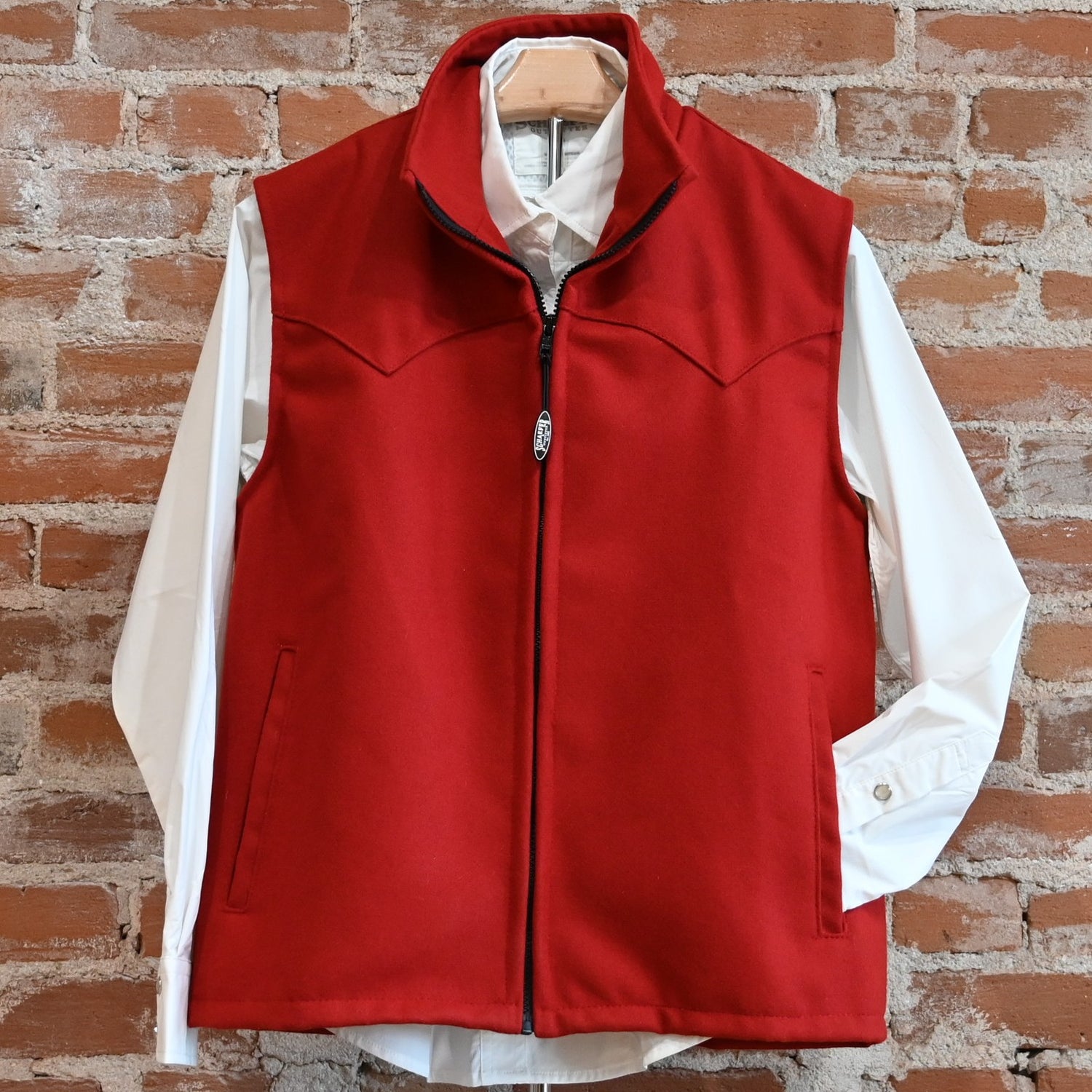View of Schaefer ladies wool Arena vest in black or red with Western yokes and storm-flap zip front