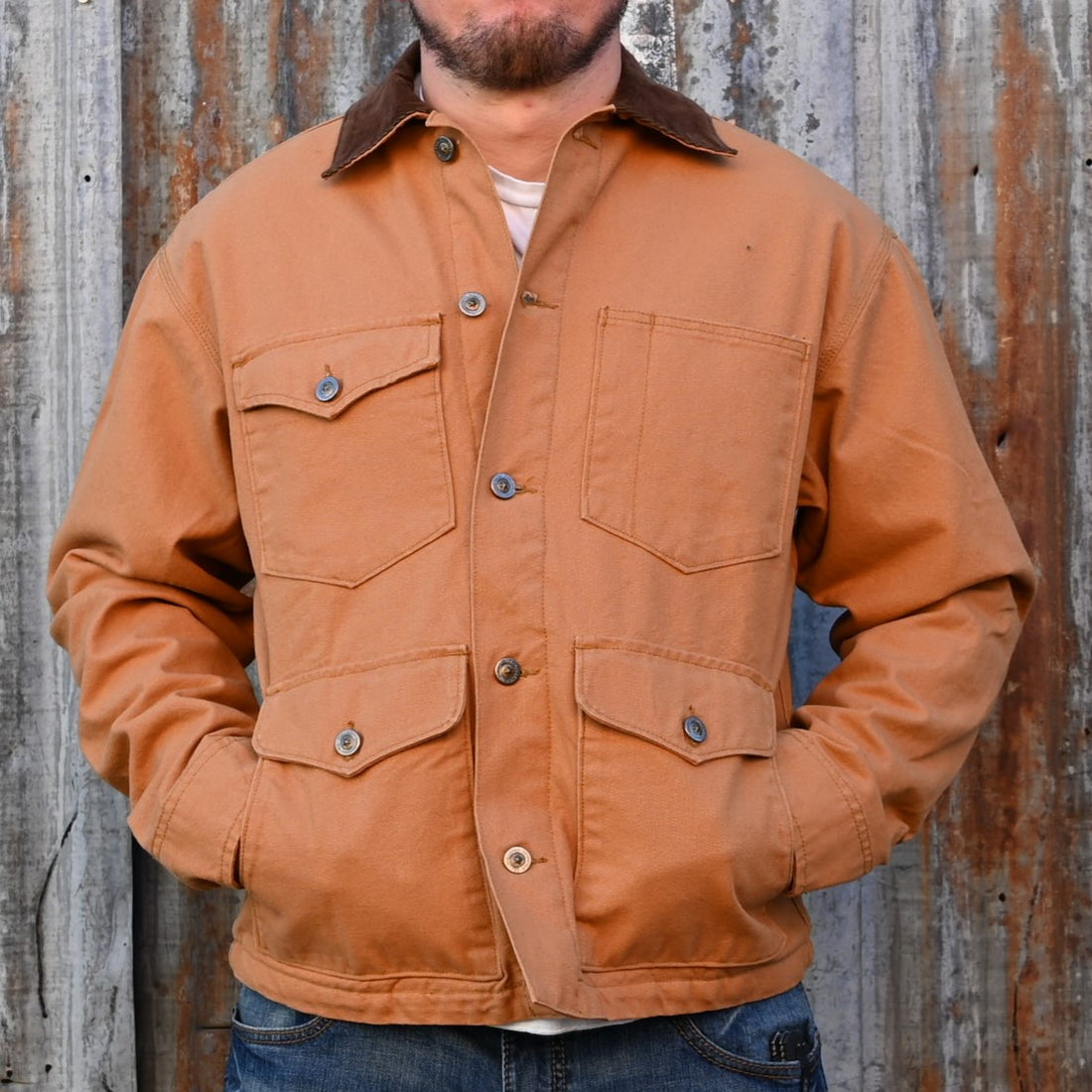 View of Schaefer saddle‑tan brush jacket with fleece blanket lining, corduroy collar, and six front pockets