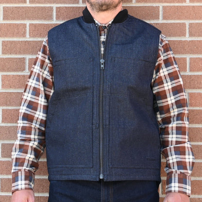 View of Filson Denim Insulated Work Vest in Raw Indigo featuring wool-blend rib-knit collar and four-pocket design