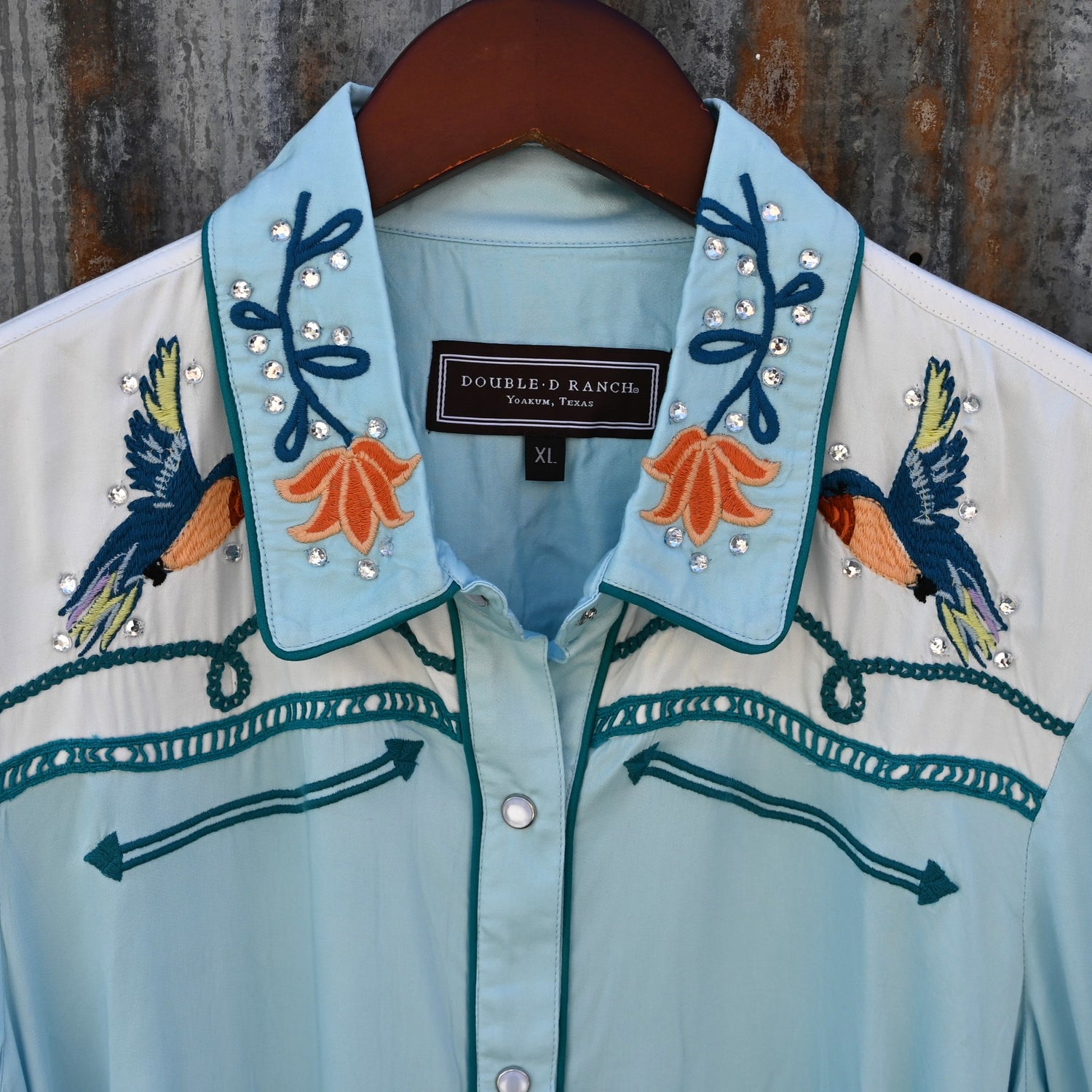 View of Double D Ranch Senoritas Rodeo Dress in Celestial Sky featuring embroidered floral print, pearl snap button closure, and drawstring waist