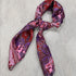 View of Purple and burgundy paisley silk wild rag with rolled edges