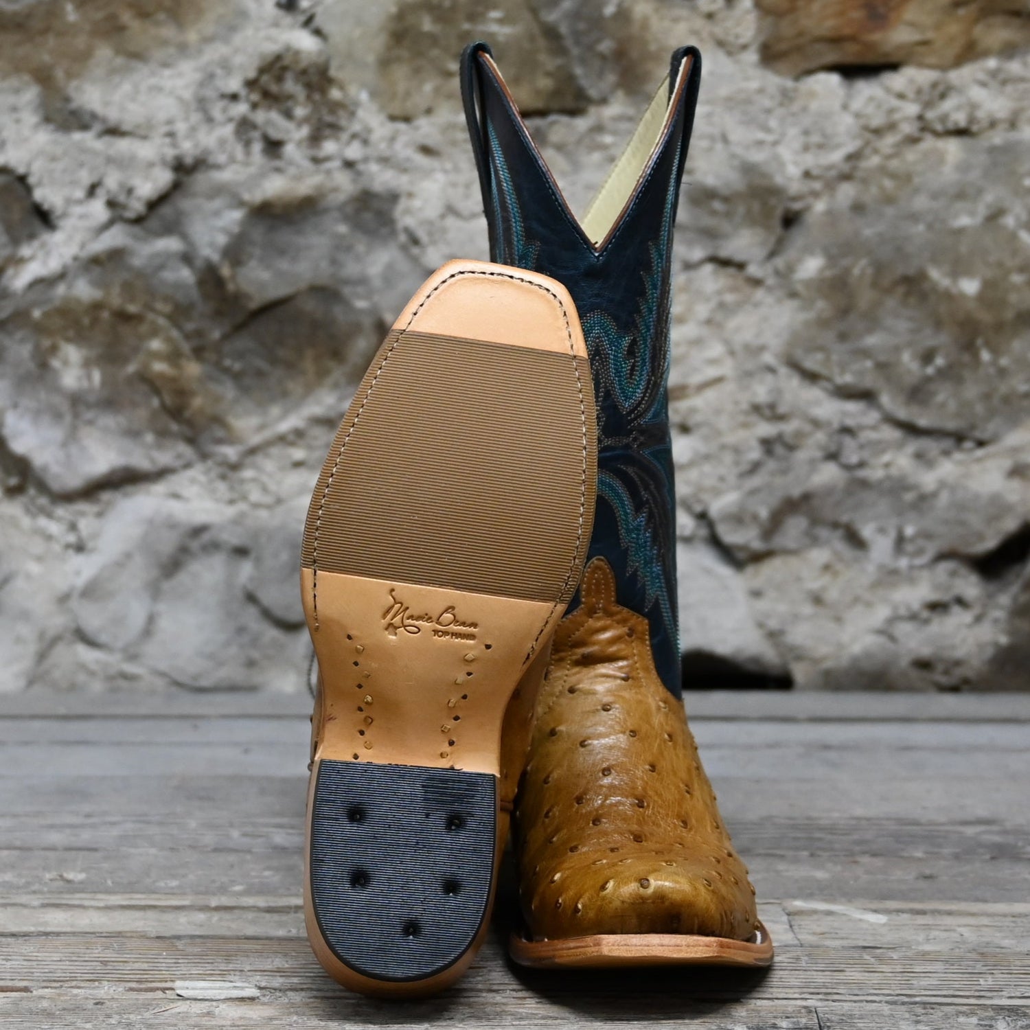 View of Macie Bean 12″ boot with antique saddle ostrich vamp and navy explosion top, TK toe and cowgirl heel