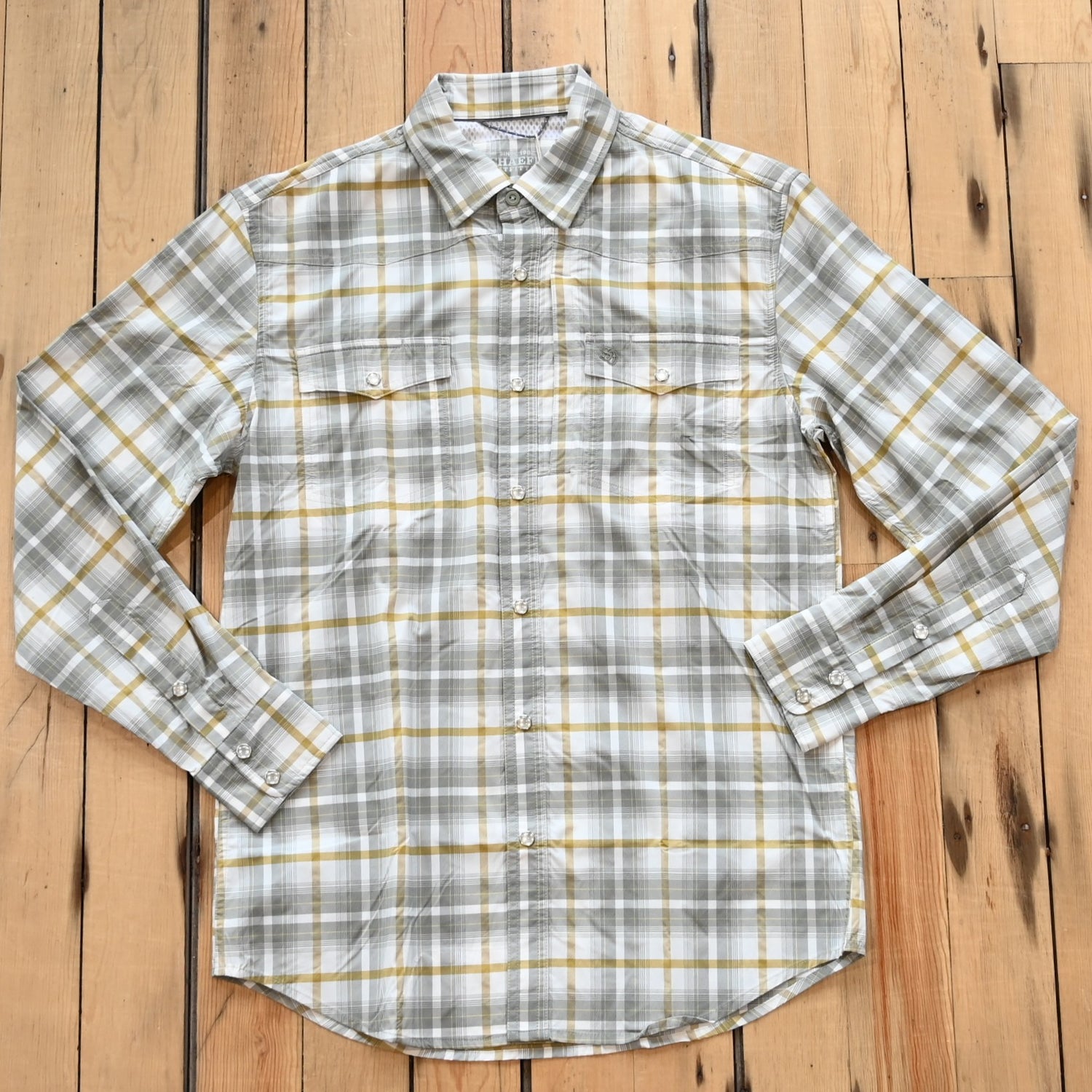 View of RangeTek Western snap shirt in gray and gold Allen plaid with mesh vent and chest pockets