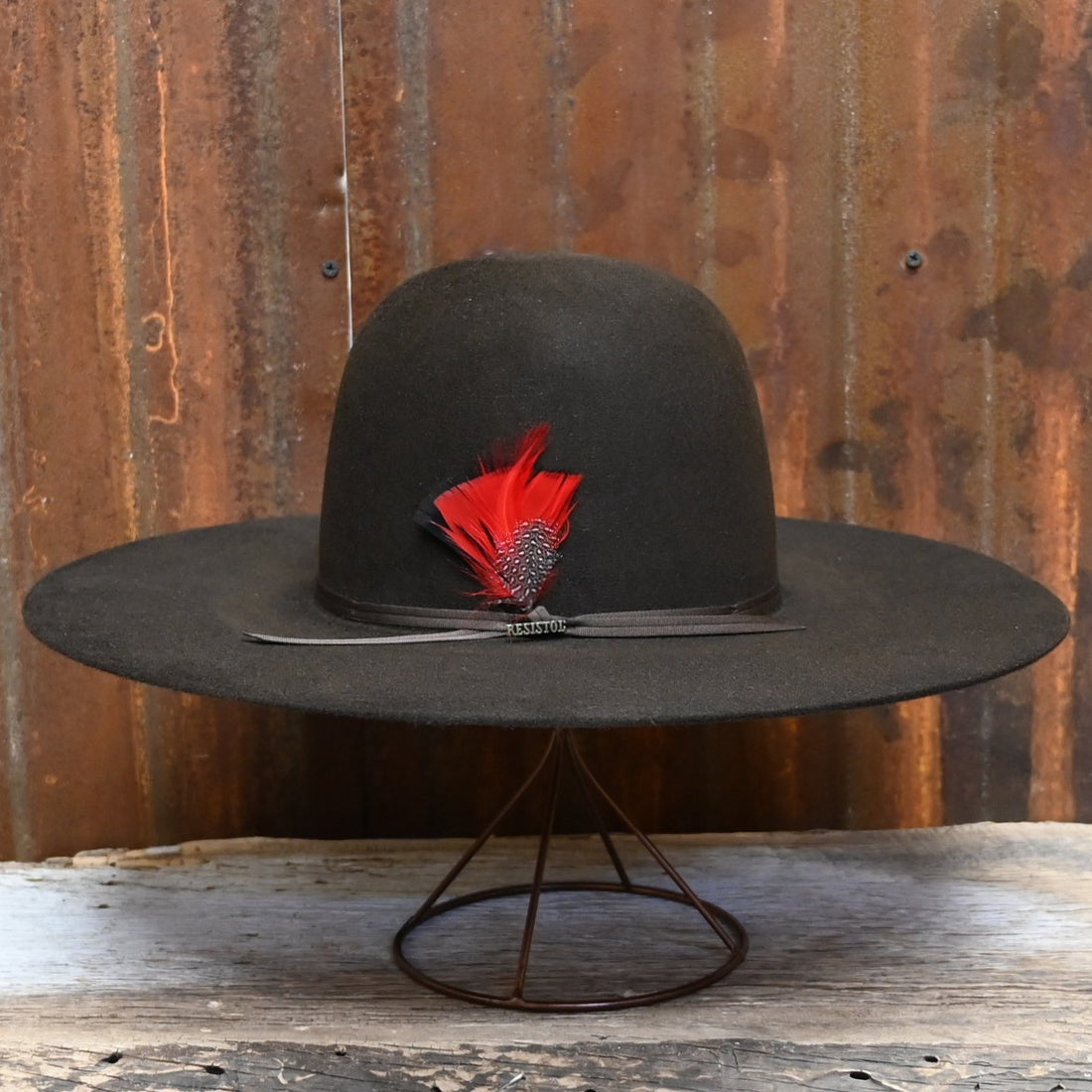 View of Side of Resistol Chute in Chocolate with Open Crown and Red Feather.