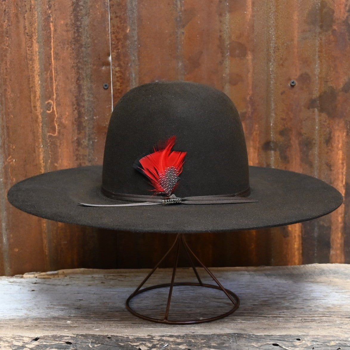 View of Side of Resistol Chute in Chocolate with Open Crown and Red Feather.