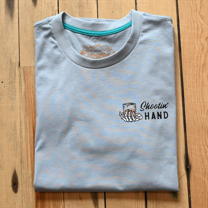 View of Sendero Big Sky Blue graphic tee with “Never drink with your shooting hand” print