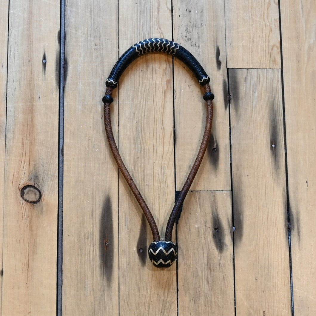 1/4 inch rawhide bosal with 16 plait construction in brown with black and white accents