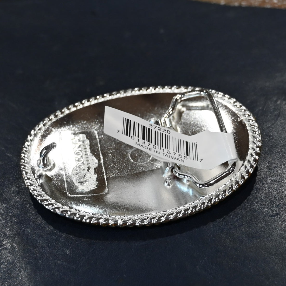 Nocona oval buckle with gold rope edge and engraved floral scroll design