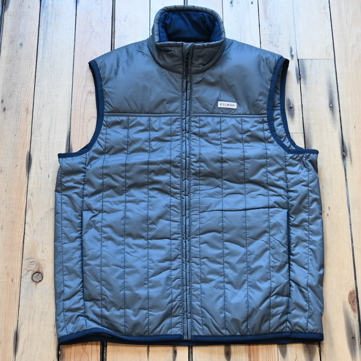 View of Filson Ultralight Vest in Storm Blue, showcasing its lightweight design and insulated features