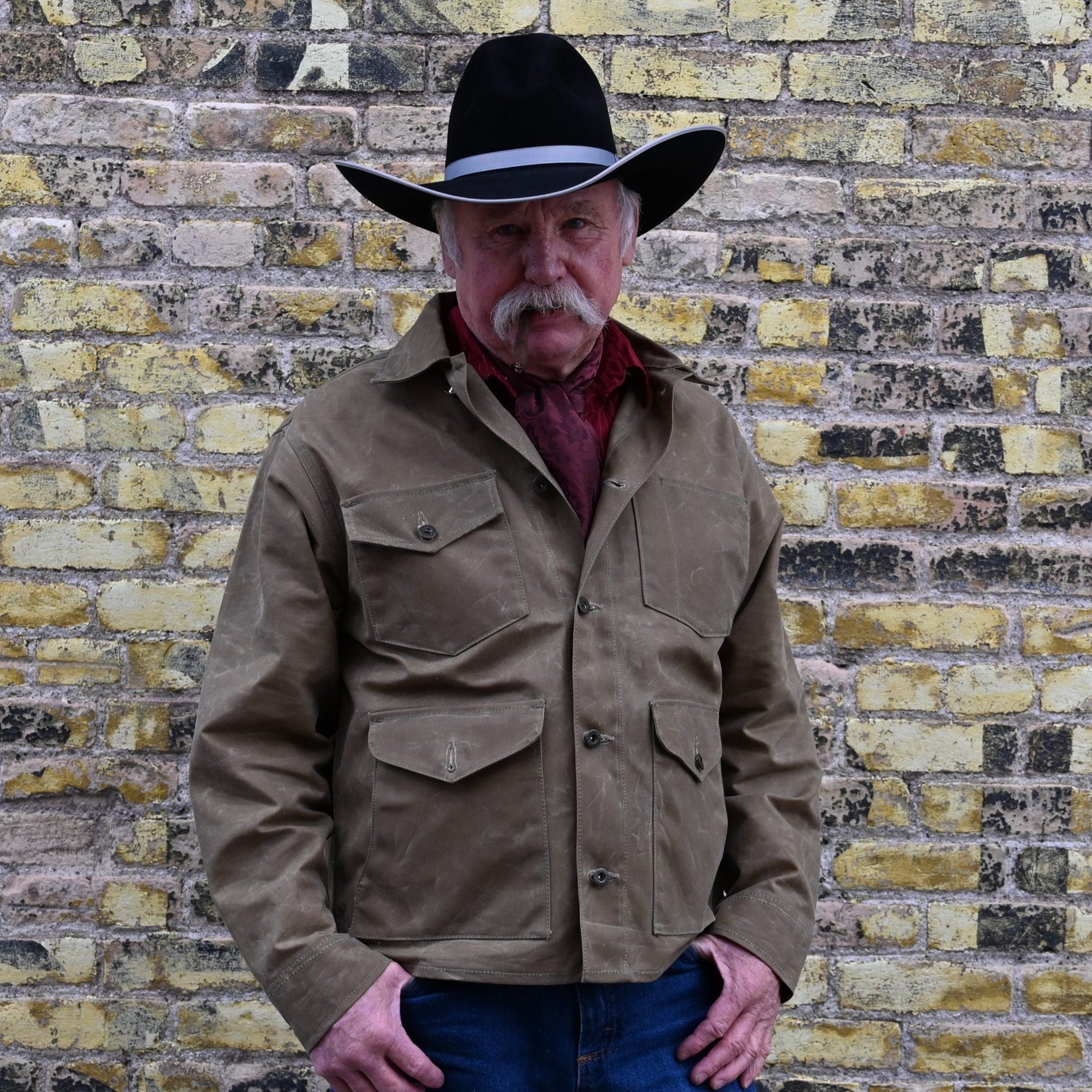 View of Schaefer ranch-style waxed cotton Mesquite Brush Jacket in oak or saddle with brass snap buttons