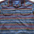 View of Pendleton men’s wool board shirt in brown multi ombré stripe with bias pockets and square hem